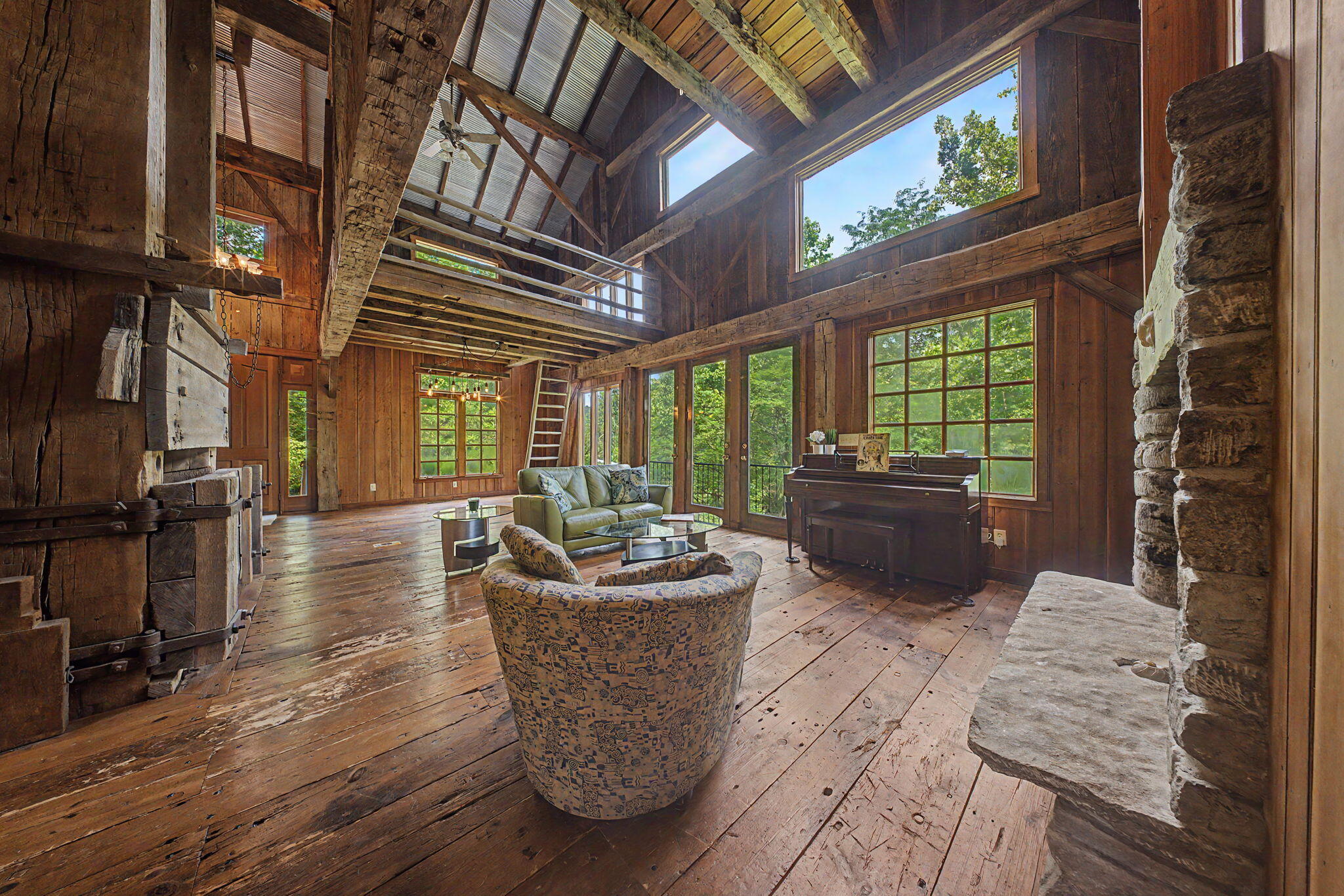 9766 Sullivan Road Union, KY 41091 - Photo 6 of 50 There are so many unique and lovely details to highlight throughout this home: the focal point of the home is the late 1800's hay press in the center of the first floor, cat walk suspended above the living room, and the home office with access via a wooden ladder.
