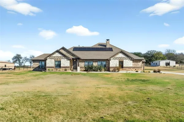 a front view of a house with swimming pool having outdoor seating