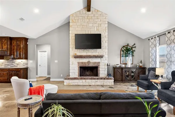 a living room with furniture fireplace and flat screen tv