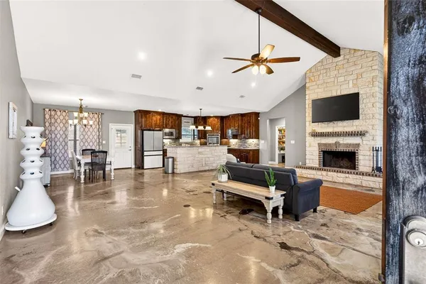 a living room with furniture a fireplace and a flat screen tv