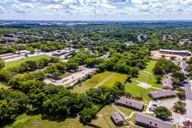 an aerial view of a houses with a swimming pool