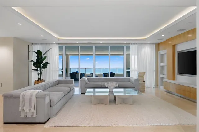 a living room with furniture a fireplace and a window