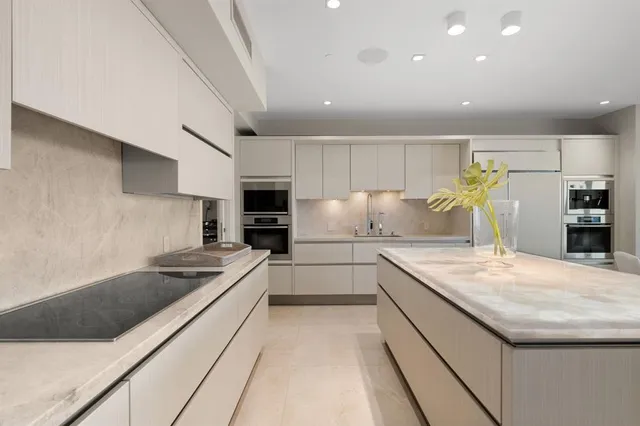a living room with furniture a floor to ceiling window and a flat screen tv