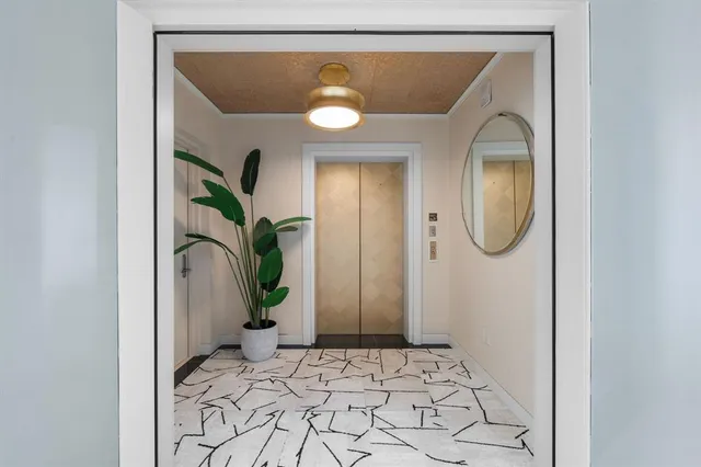 a living room with furniture and a view of kitchen