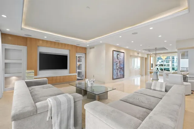 a view of a patio with couches potted plants and a big yard