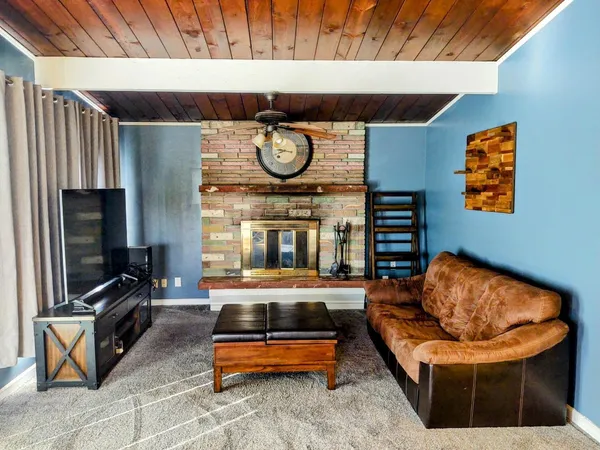 a kitchen with stainless steel appliances granite countertop a stove a refrigerator a kitchen island with a dining table and chairs