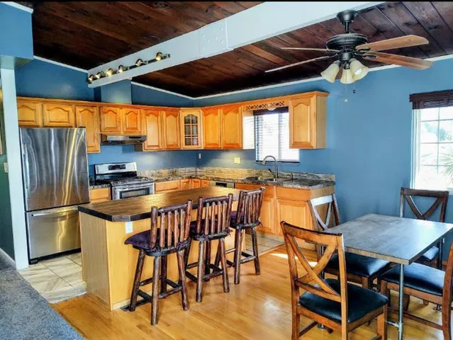 a view of a dining room with furniture and window