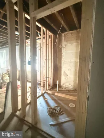 a view of an empty room with wooden floor and a glass door
