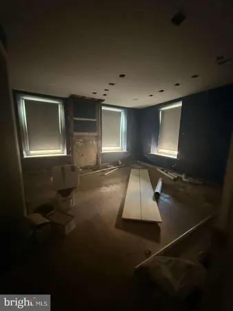 a room with pool table and windows