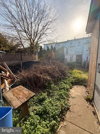 a wooden bench sitting in middle of a yard