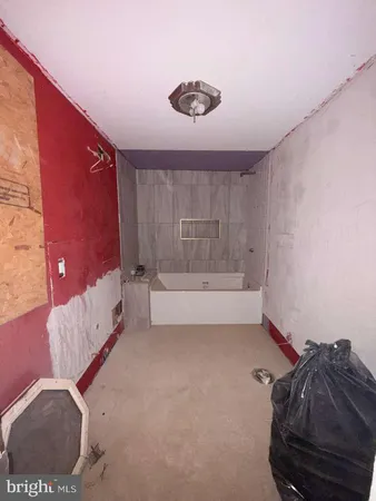 a bathroom with a tub and a shower