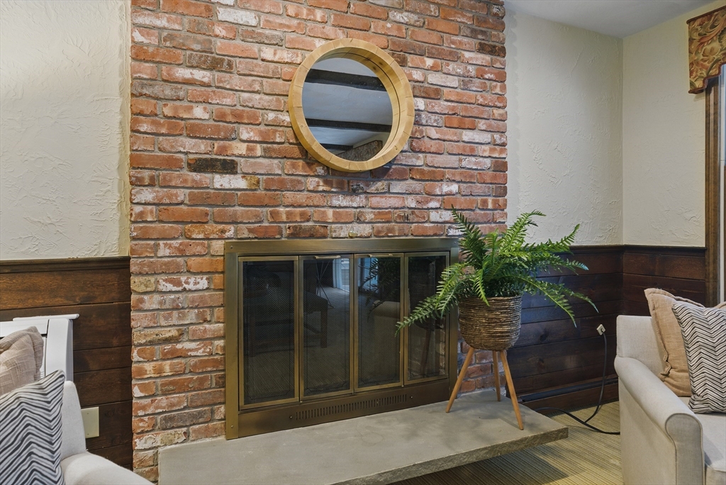 14 Harvard Drive Bedford, MA 01730 - Photo 11 of 40 a living room with furniture and a potted plant