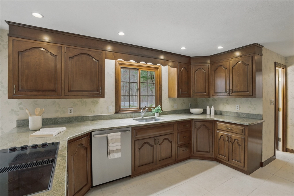 14 Harvard Drive Bedford, MA 01730 - Photo 15 of 40 a kitchen with a sink stove and cabinets