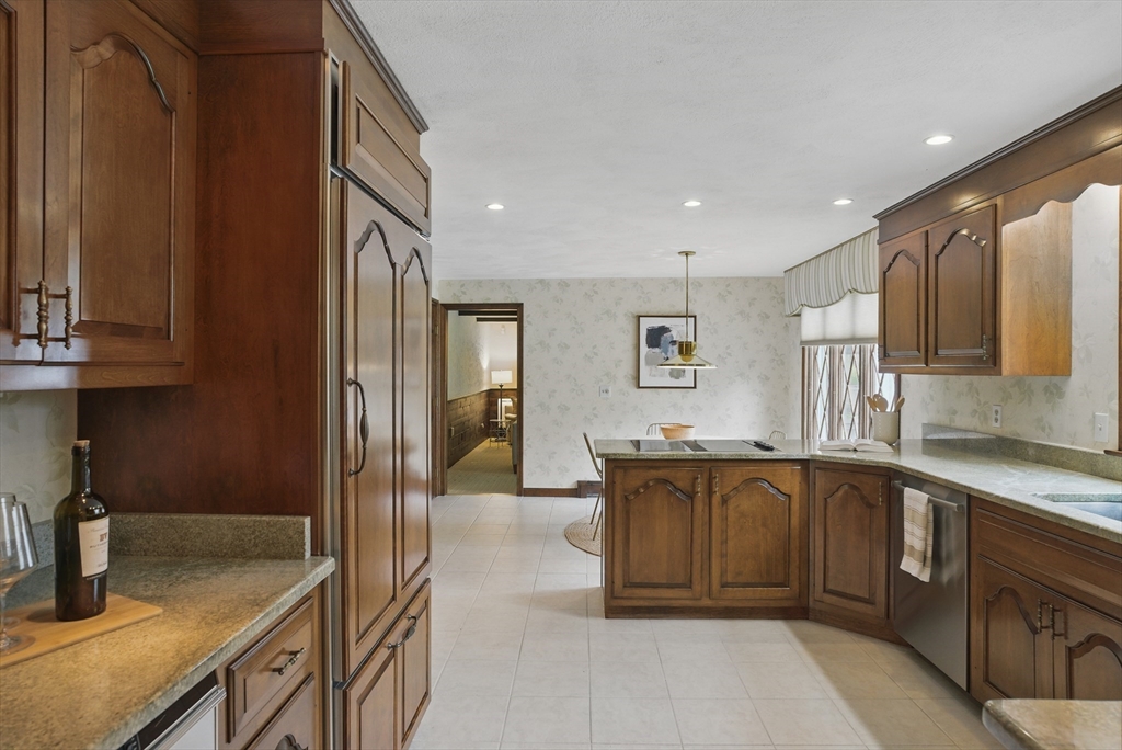 14 Harvard Drive Bedford, MA 01730 - Photo 19 of 40 a kitchen with stainless steel appliances granite countertop a sink and cabinets