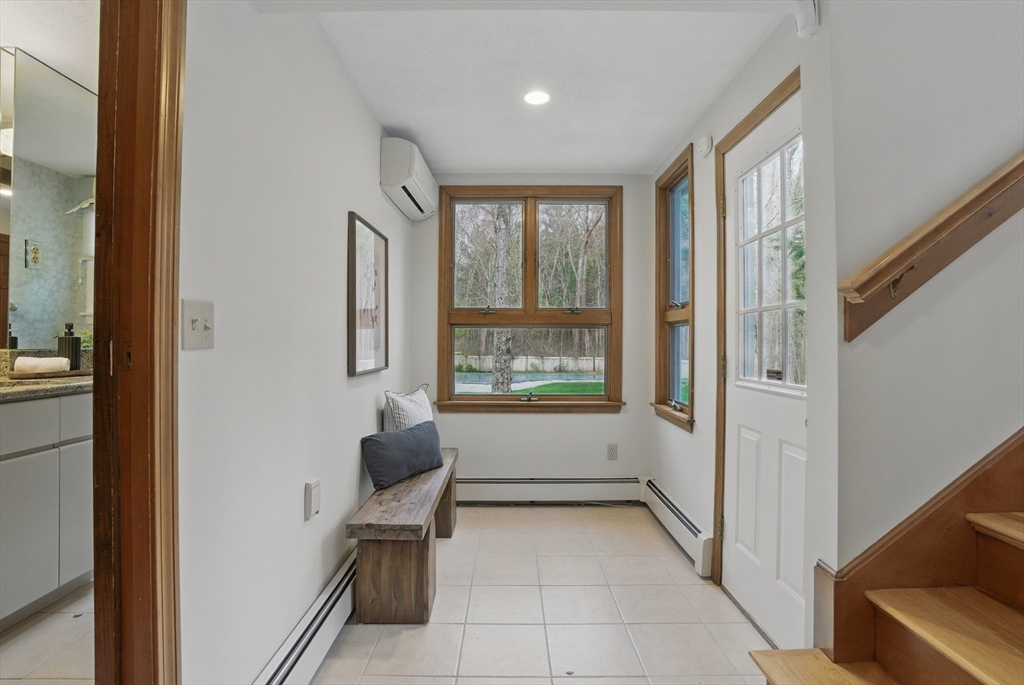 14 Harvard Drive Bedford, MA 01730 - Photo 21 of 40 a hallway with a window and a couch