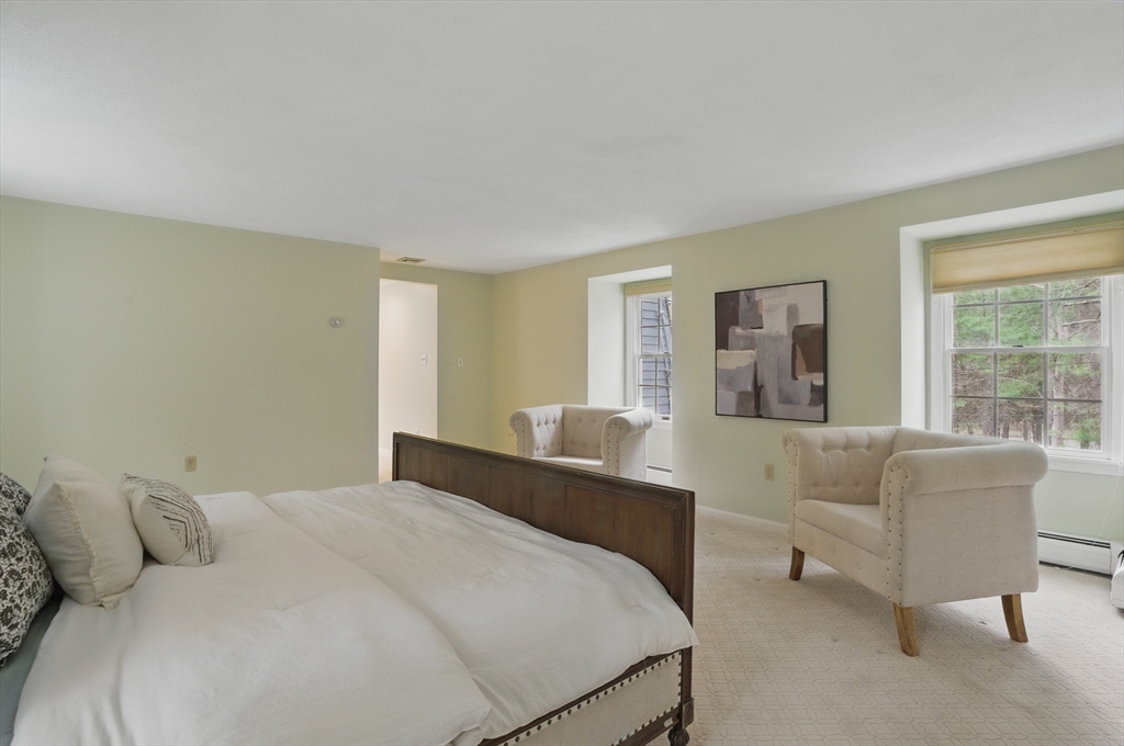 14 Harvard Drive Bedford, MA 01730 - Photo 22 of 40 a bedroom with a bed and a couch with window