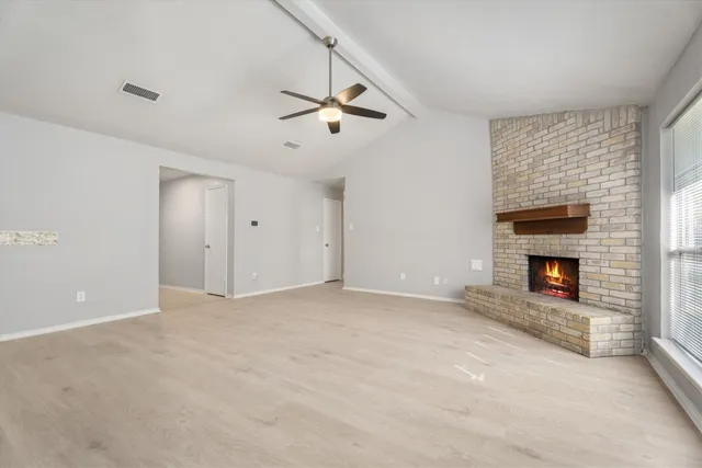 a view of an empty room with a fireplace