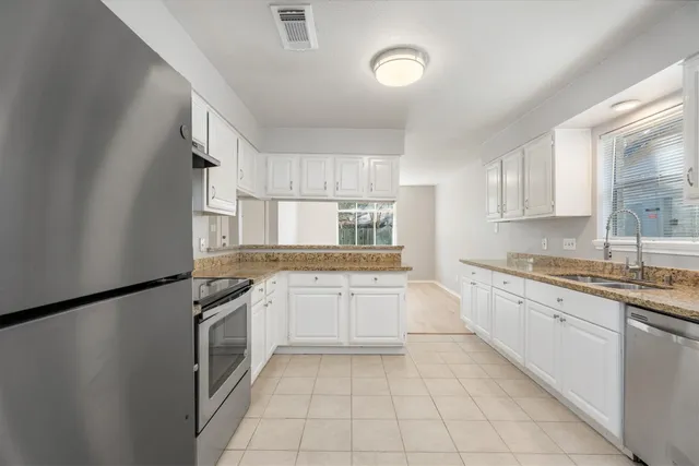 a kitchen with a sink stove and cabinets