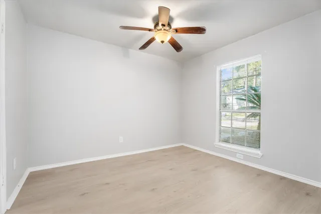 a view of room with a ceiling fan and window