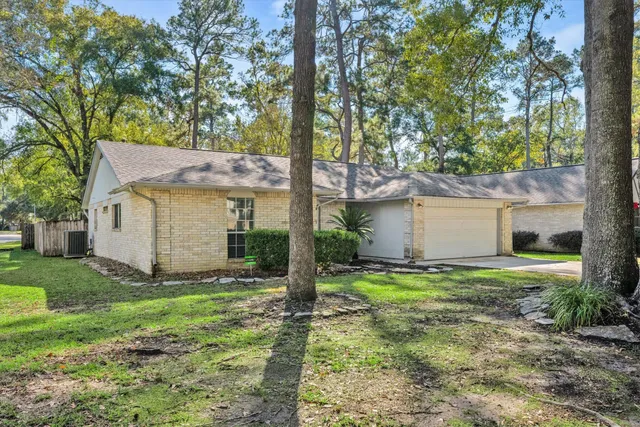 a view of a house with yard and a tree