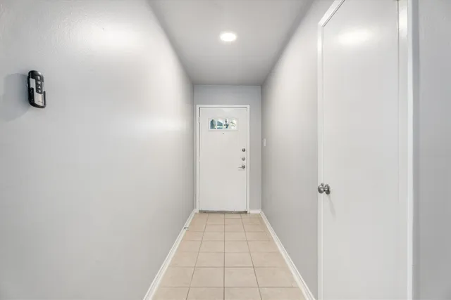 a view of a hallway with a white door