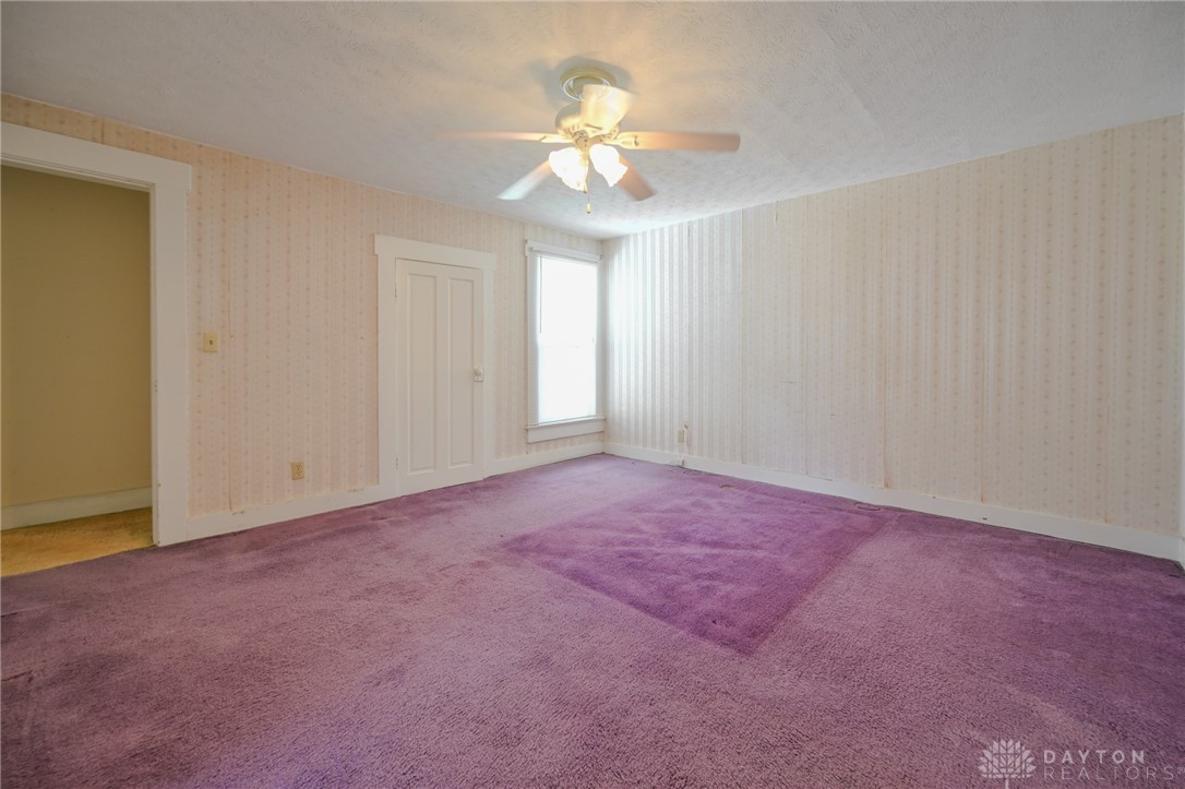 3057 Springfield Xenia Road Springfield, OH 45506 - Photo 5 of 37 This spacious room features a ceiling fan, a window, and comfortable carpet flooring.