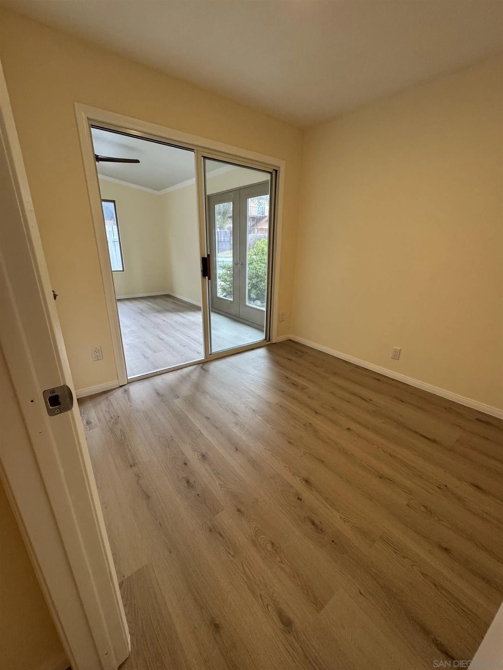 2441 Gladiola Drive Campo, CA 91906 - Photo 15 of 17 a view of an empty room with wooden floor and a window