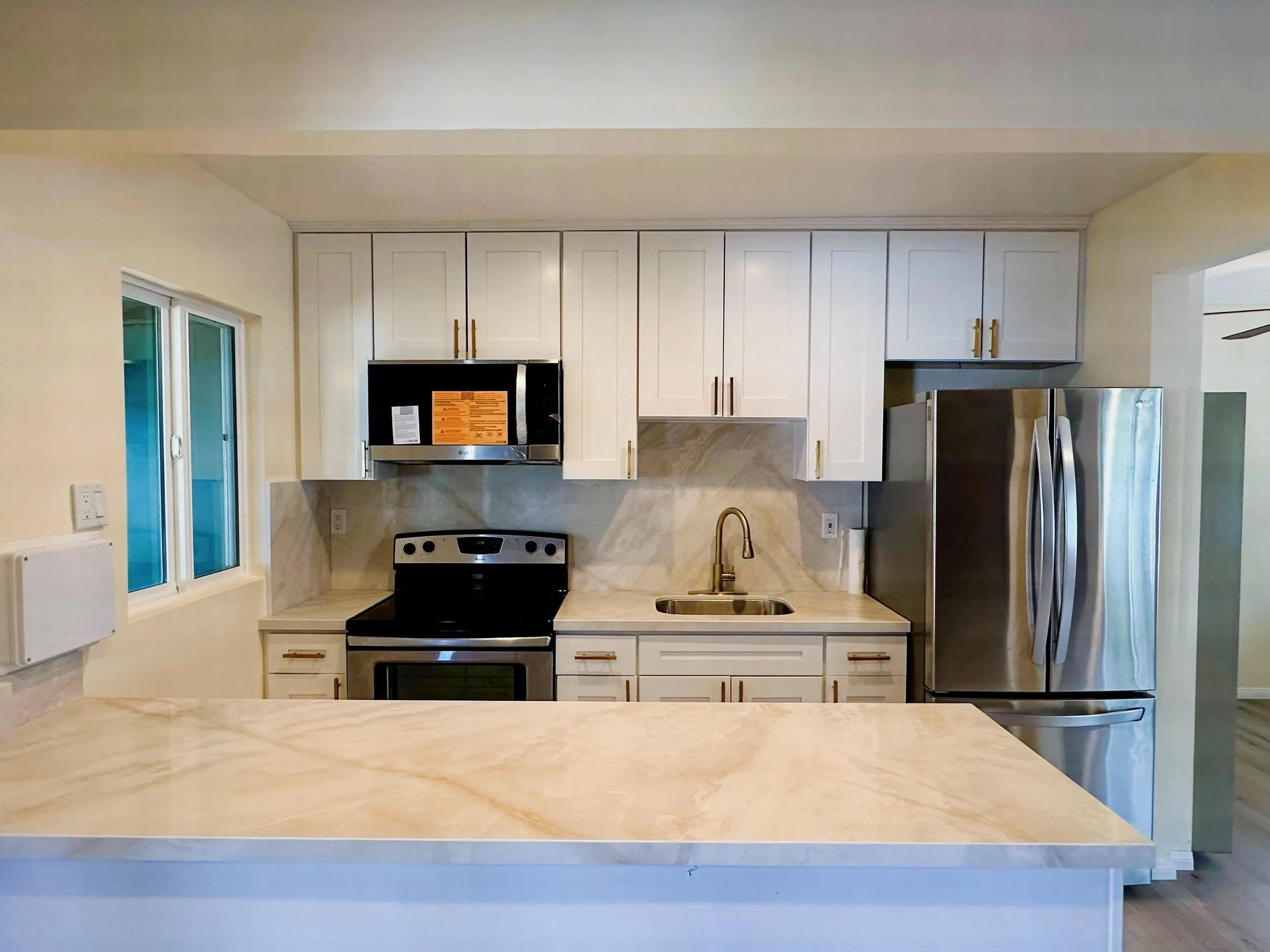 2441 Gladiola Drive Campo, CA 91906 - Photo 2 of 17 a kitchen with granite countertop a refrigerator and a stove top oven
