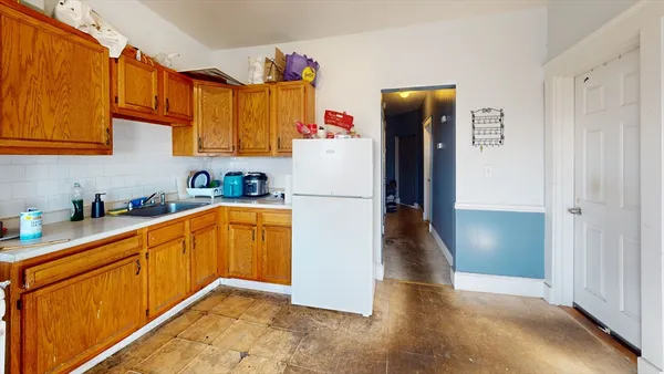 a kitchen with stainless steel appliances granite countertop a refrigerator and a sink