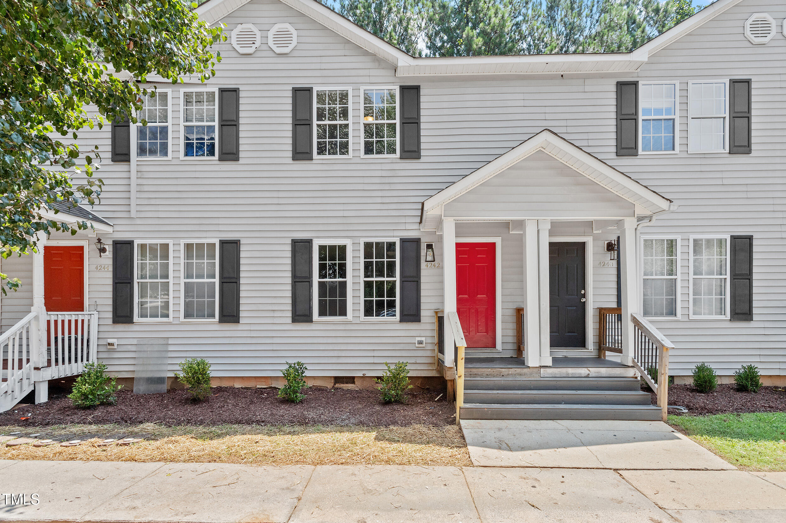 a view of a house with a patio and a fire pit