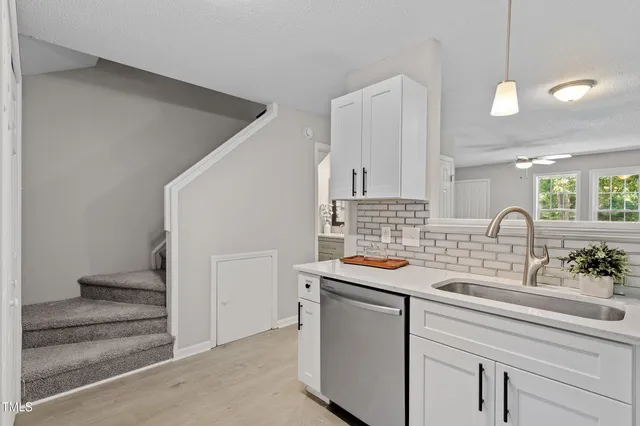 a kitchen with a sink and cabinets