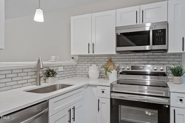 a kitchen with a sink stove and microwave