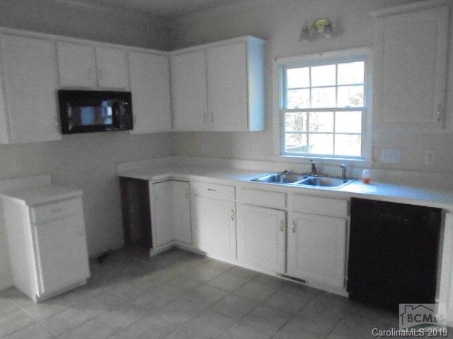 301 General Griffith Circle Rutherfordton, NC 28139 - Photo 11 of 17 a kitchen with white cabinets and a sink