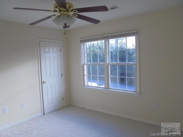 301 General Griffith Circle Rutherfordton, NC 28139 - Photo 6 of 17 an empty room with a window and a fan
