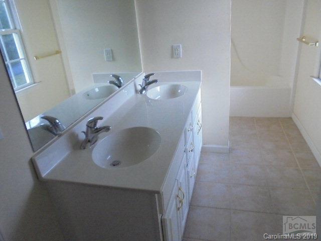 301 General Griffith Circle Rutherfordton, NC 28139 - Photo 7 of 17 a bathroom with a sink and mirror