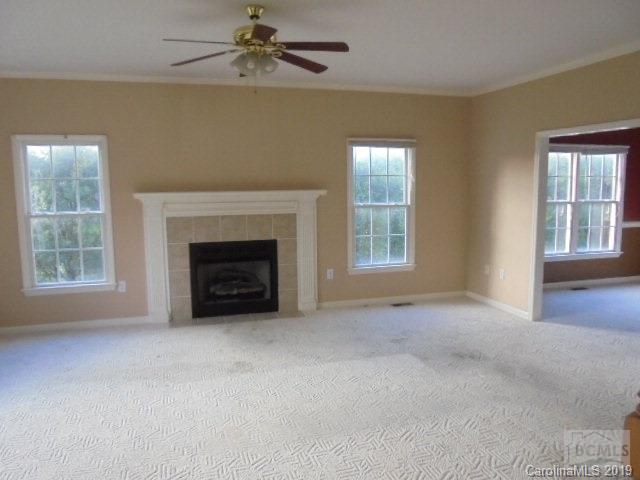 301 General Griffith Circle Rutherfordton, NC 28139 - Photo 8 of 17 an empty room with windows and fireplace