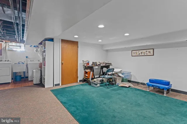 a view of a room with furniture and a fan