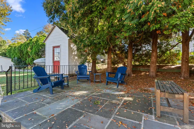 a view of a house with backyard sitting area and garden
