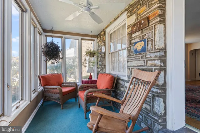a outdoor living room with furniture and a window