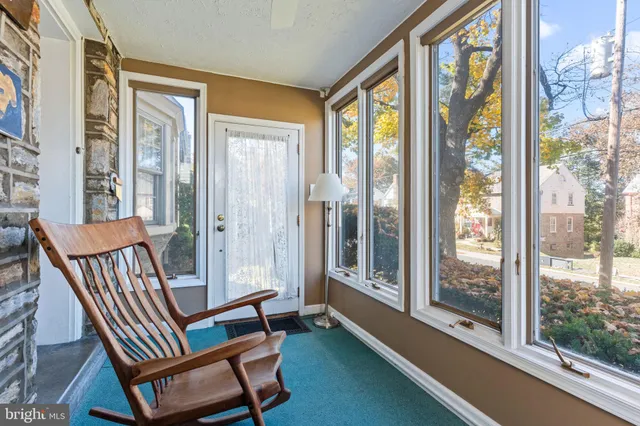 a view of a room with furniture and wooden floor