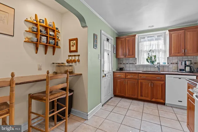 a kitchen with stainless steel appliances a stove a sink and a refrigerator