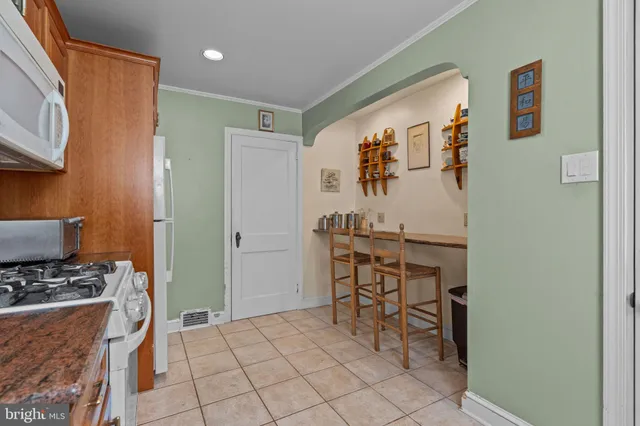a view of kitchen with sink and breakfast area