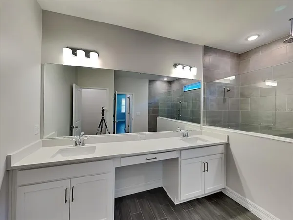 a bathroom with a sink double vanity and a mirror