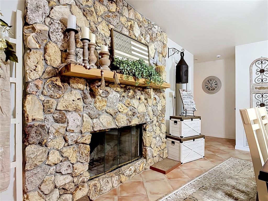 1395 Maytown Road Osteen, FL 32764 - Photo 16 of 65 a living room with a fireplace and a flat screen tv