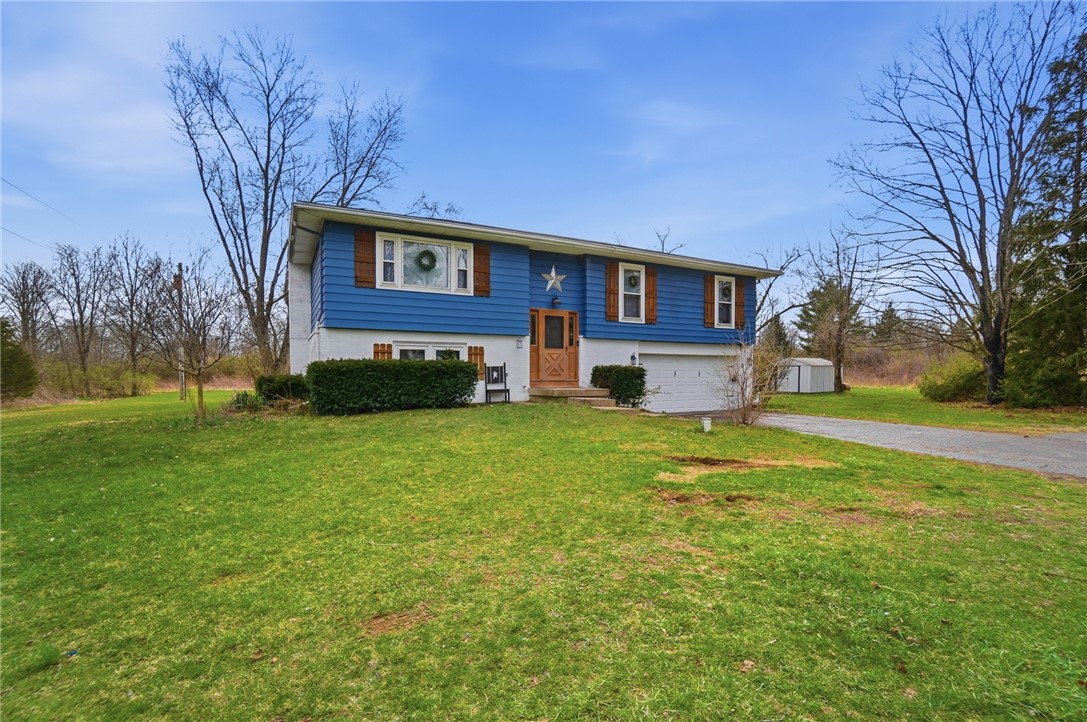 290 Ginghamsburg Road Tipp City, OH 45371 - Photo 2 of 49 This charming home offers a welcoming facade with a vibrant blue exterior and ample green space.