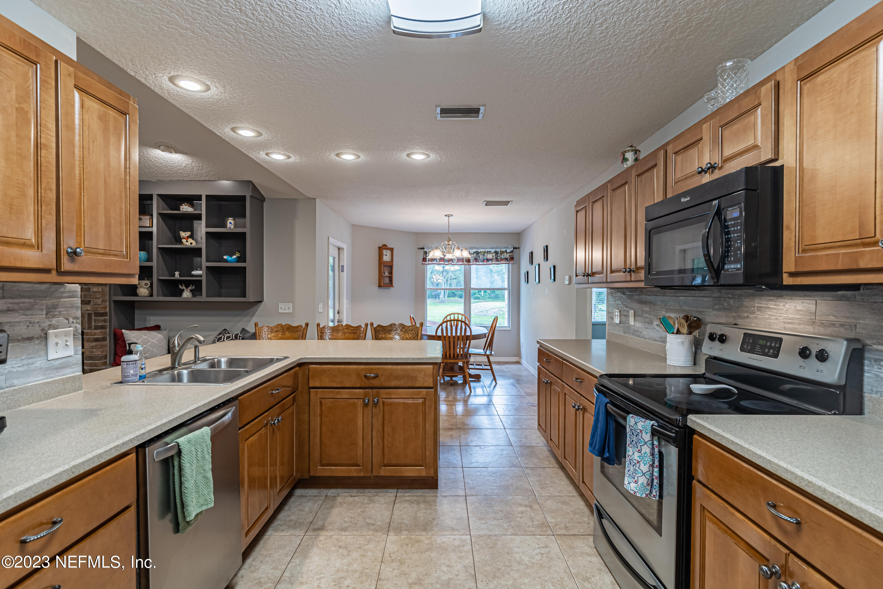 1193 Marlee Road St. Johns, FL 32259 - Photo 11 of 63 a kitchen with stainless steel appliances granite countertop a sink stove and microwave