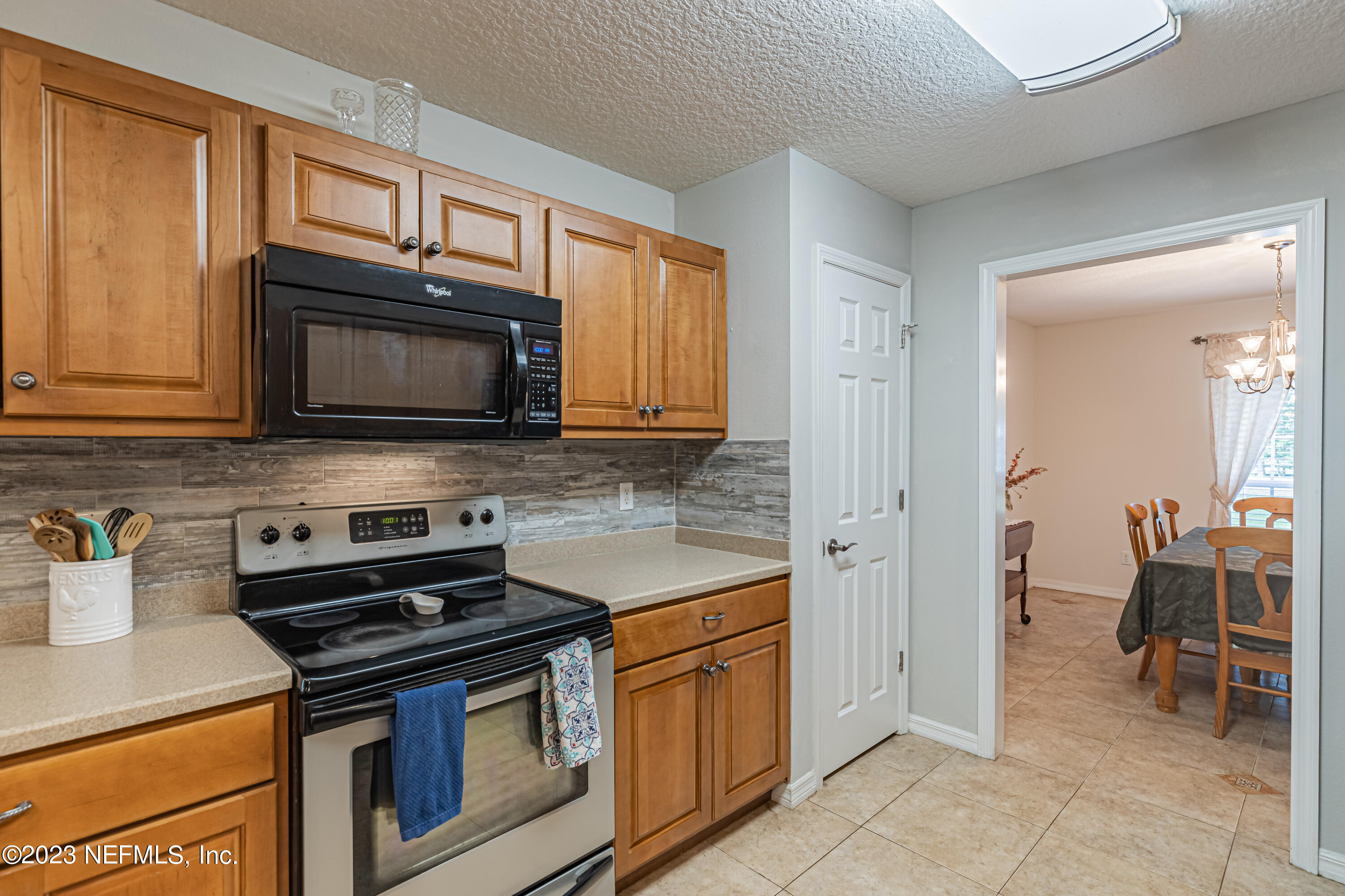1193 Marlee Road St. Johns, FL 32259 - Photo 12 of 63 a kitchen with stainless steel appliances granite countertop a stove microwave and cabinets