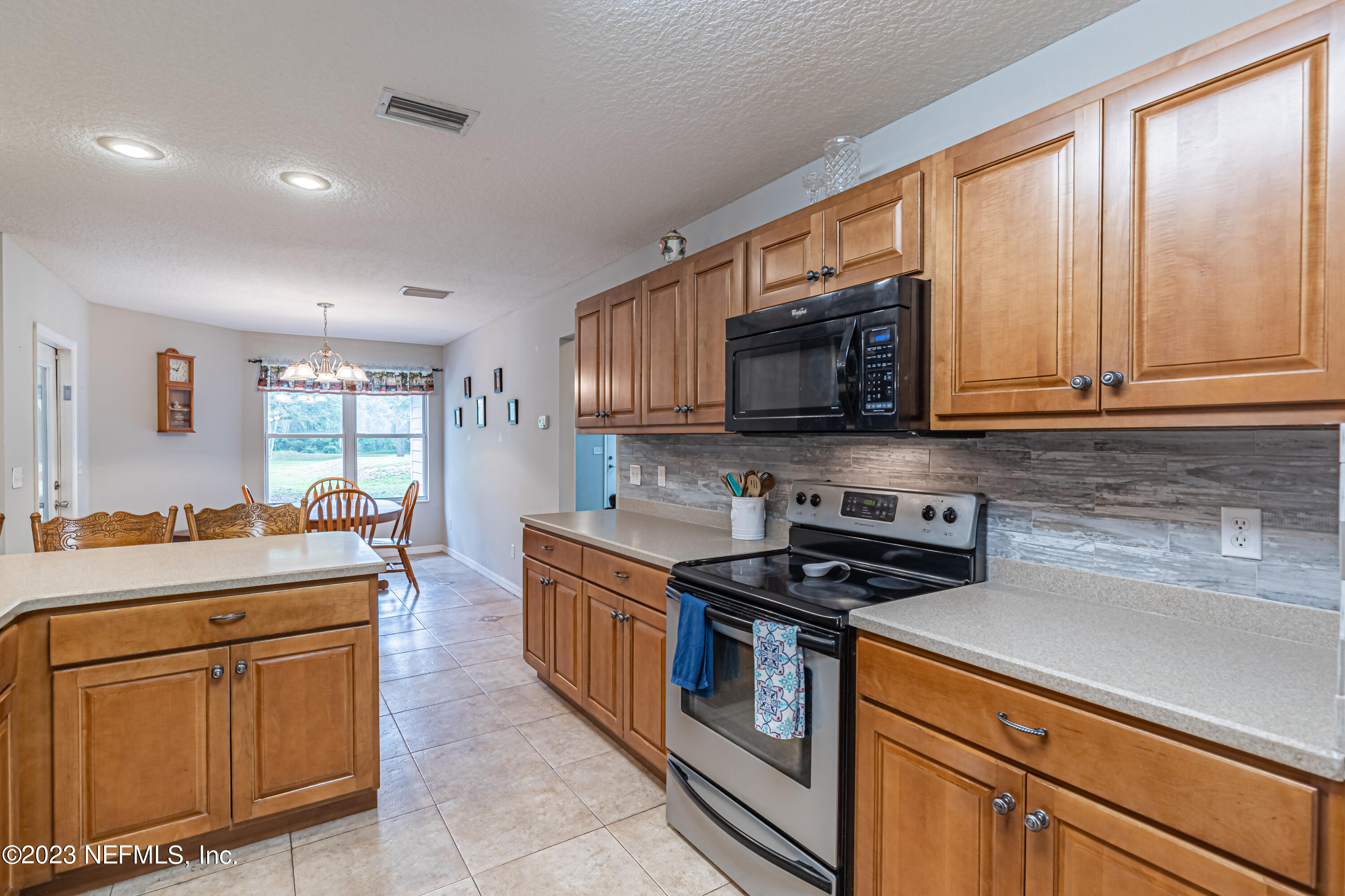 1193 Marlee Road St. Johns, FL 32259 - Photo 13 of 63 a kitchen with stainless steel appliances granite countertop a stove a sink and a microwave