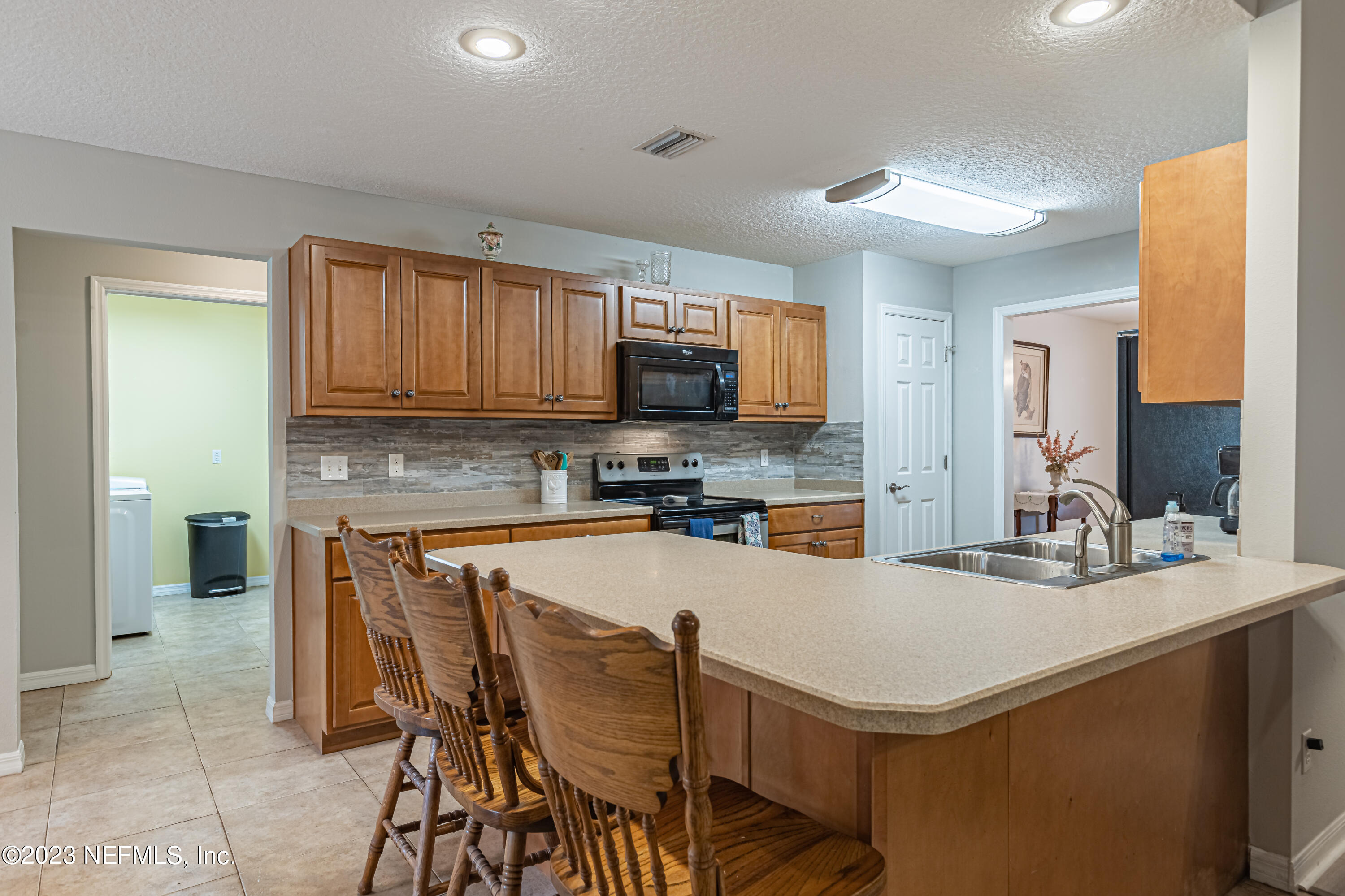 1193 Marlee Road St. Johns, FL 32259 - Photo 17 of 63 a kitchen with a sink a microwave and chairs