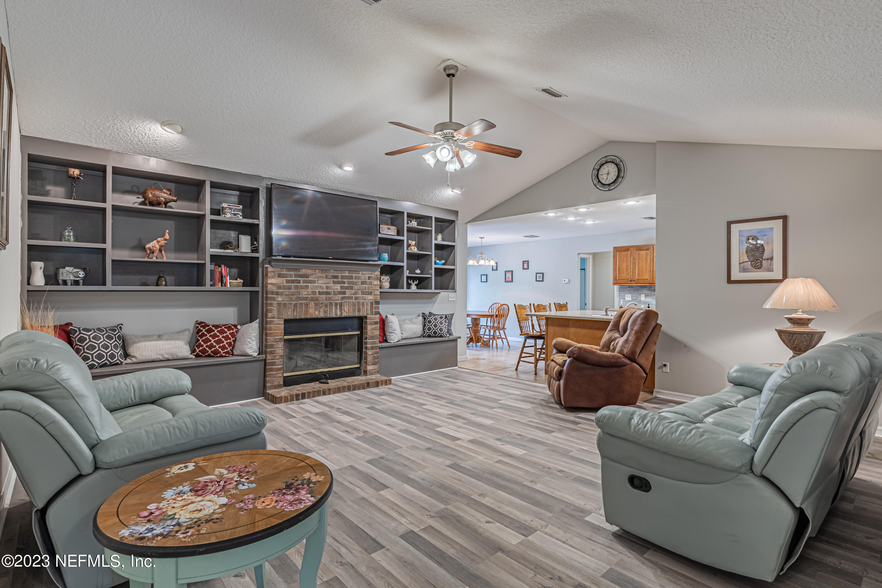 1193 Marlee Road St. Johns, FL 32259 - Photo 22 of 63 a living room with furniture a fireplace and a chandelier